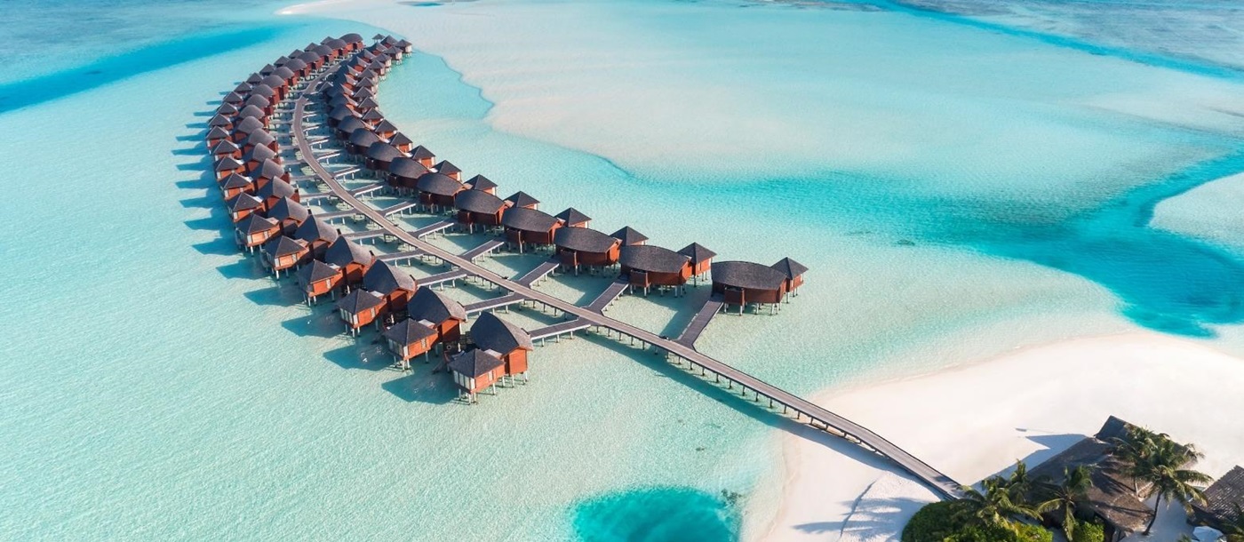 Aerial view of Water villas at luxury resort Anantara Dhigu in the Maldives