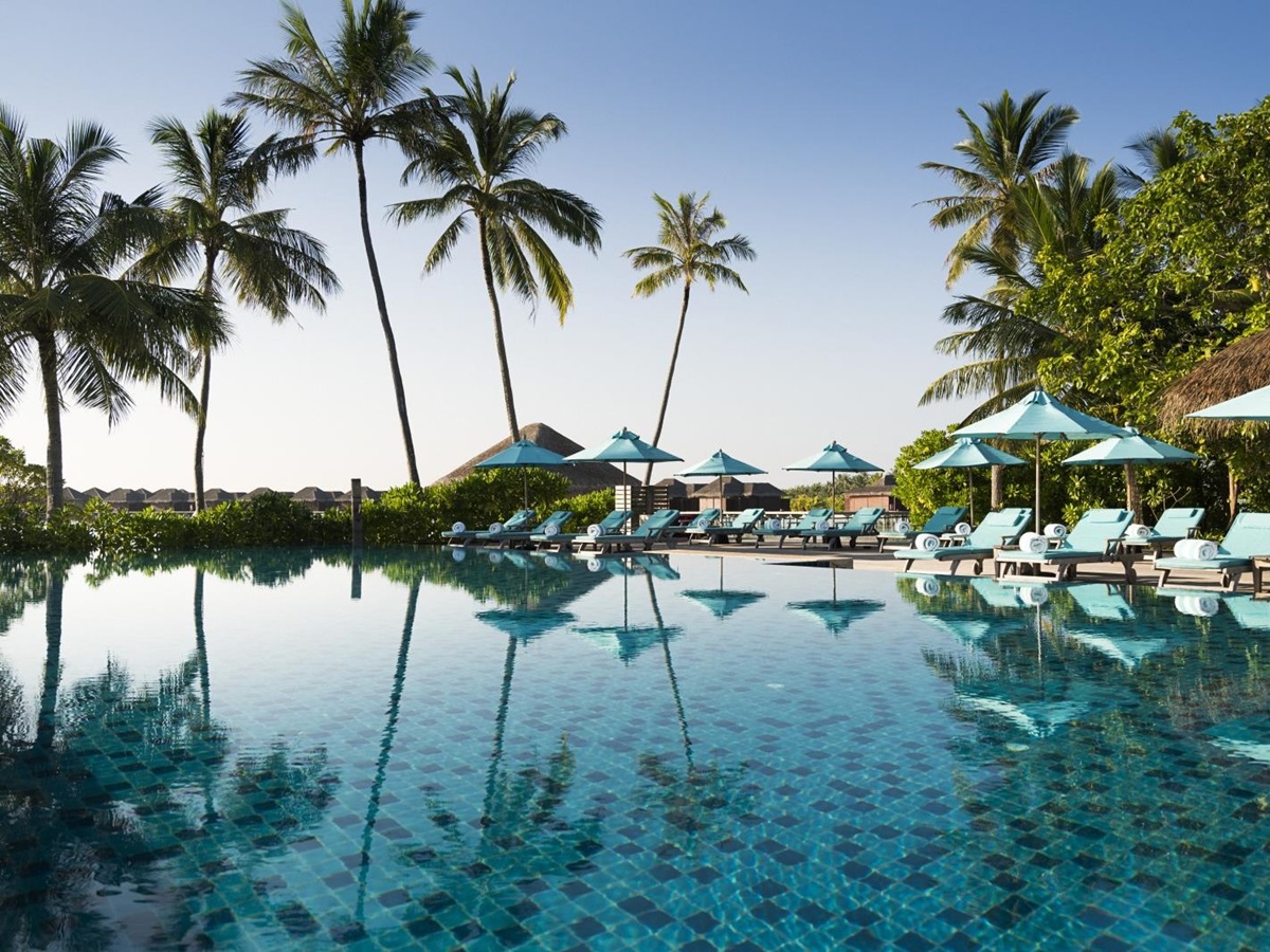Main pool with loungers and parasols at luxury resort Anantara Veli in the Maldives