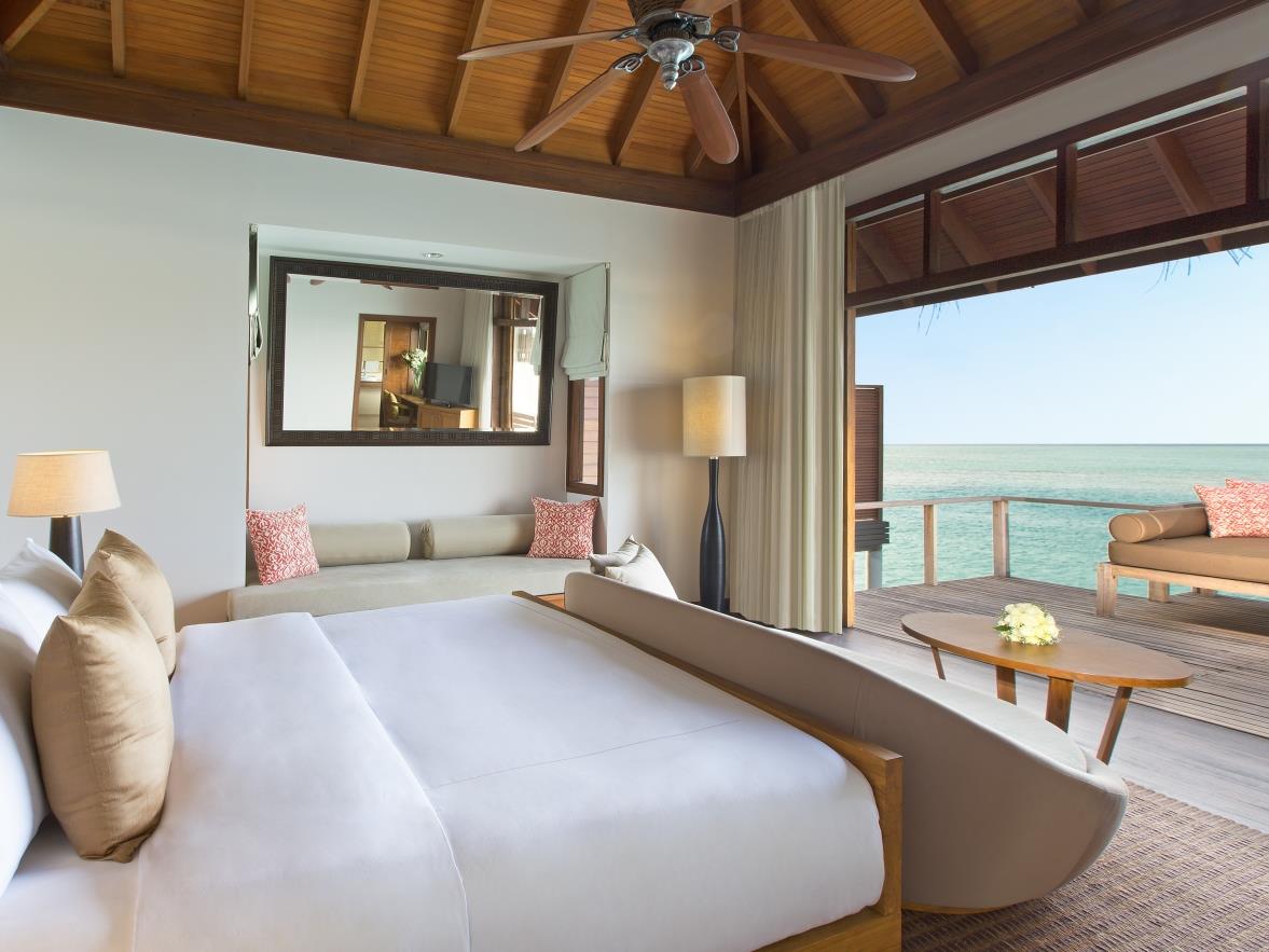 Bedroom of a Superior Overwater Bungalow at luxury resort Anantara Veli in the Maldives