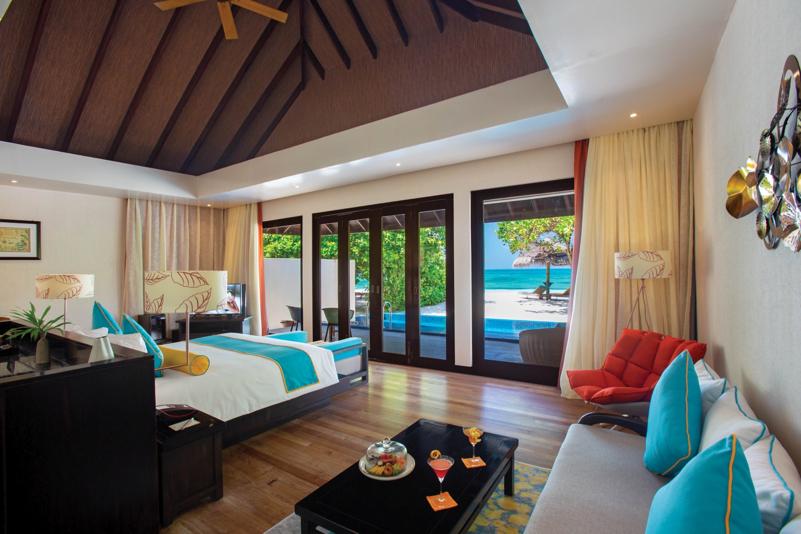 Interior of a Sunset Pool Villa with views over the private pool, white sand beach and Indian Ocean at luxury resort Atmosphere Kanifushi in the Maldives