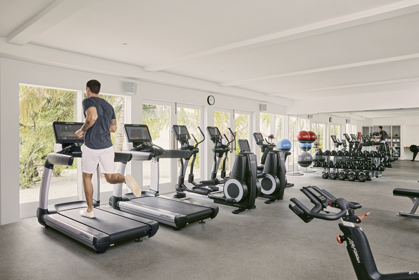 Man working out in the gym at luxury resort Cocoa Island in the Maldives