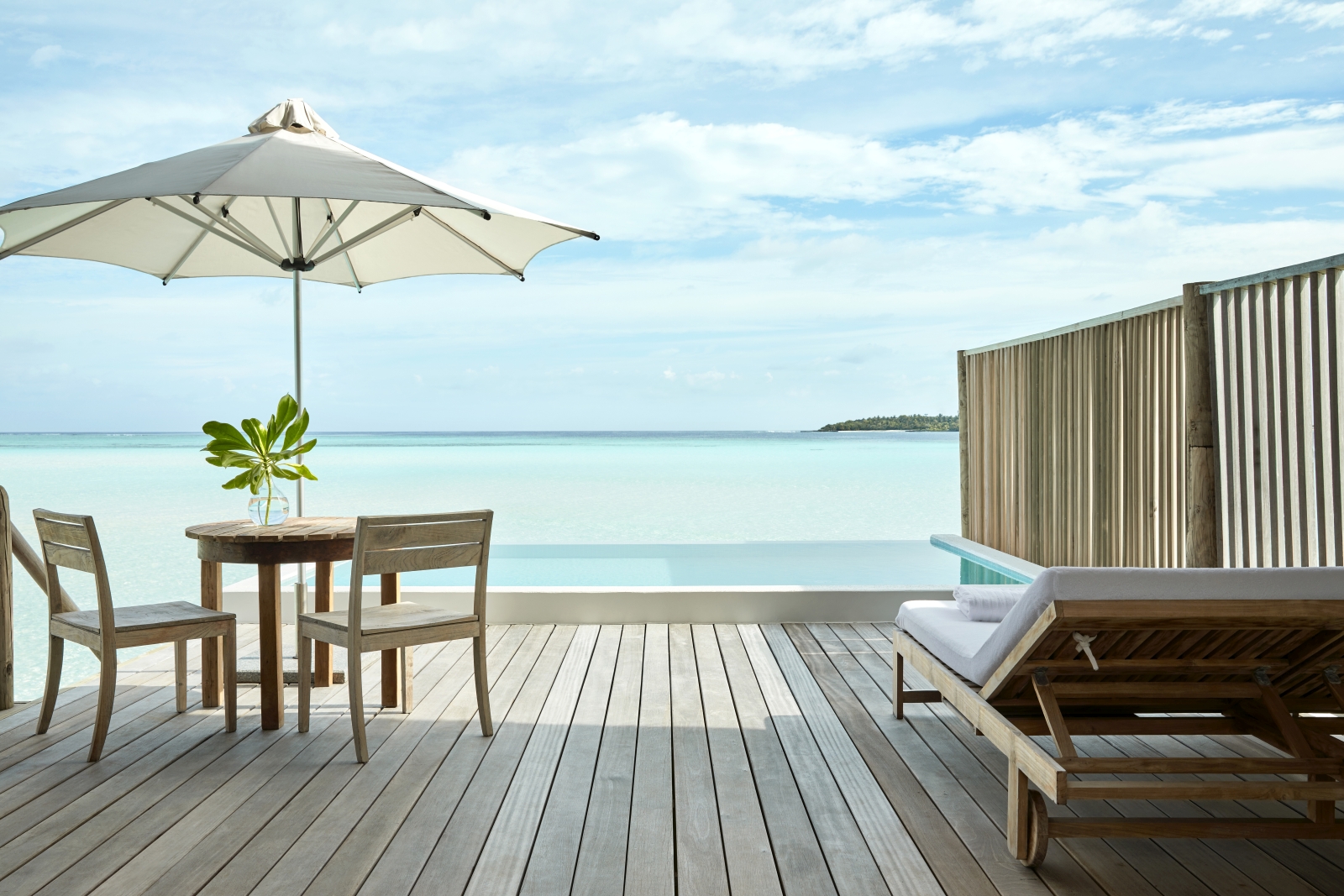 Private deck of a one bedroom water villa at luxury resort Cocoa Island in the Maldives