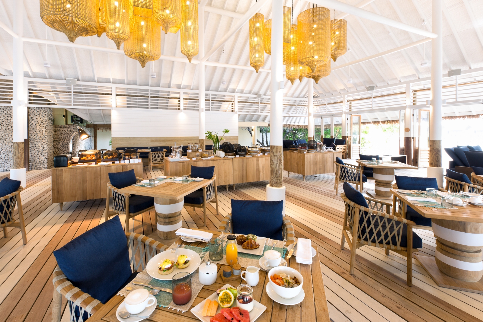 Interior of Ufaa Restaurant set for breakfast at luxury resort Cocoa Island in the Maldives