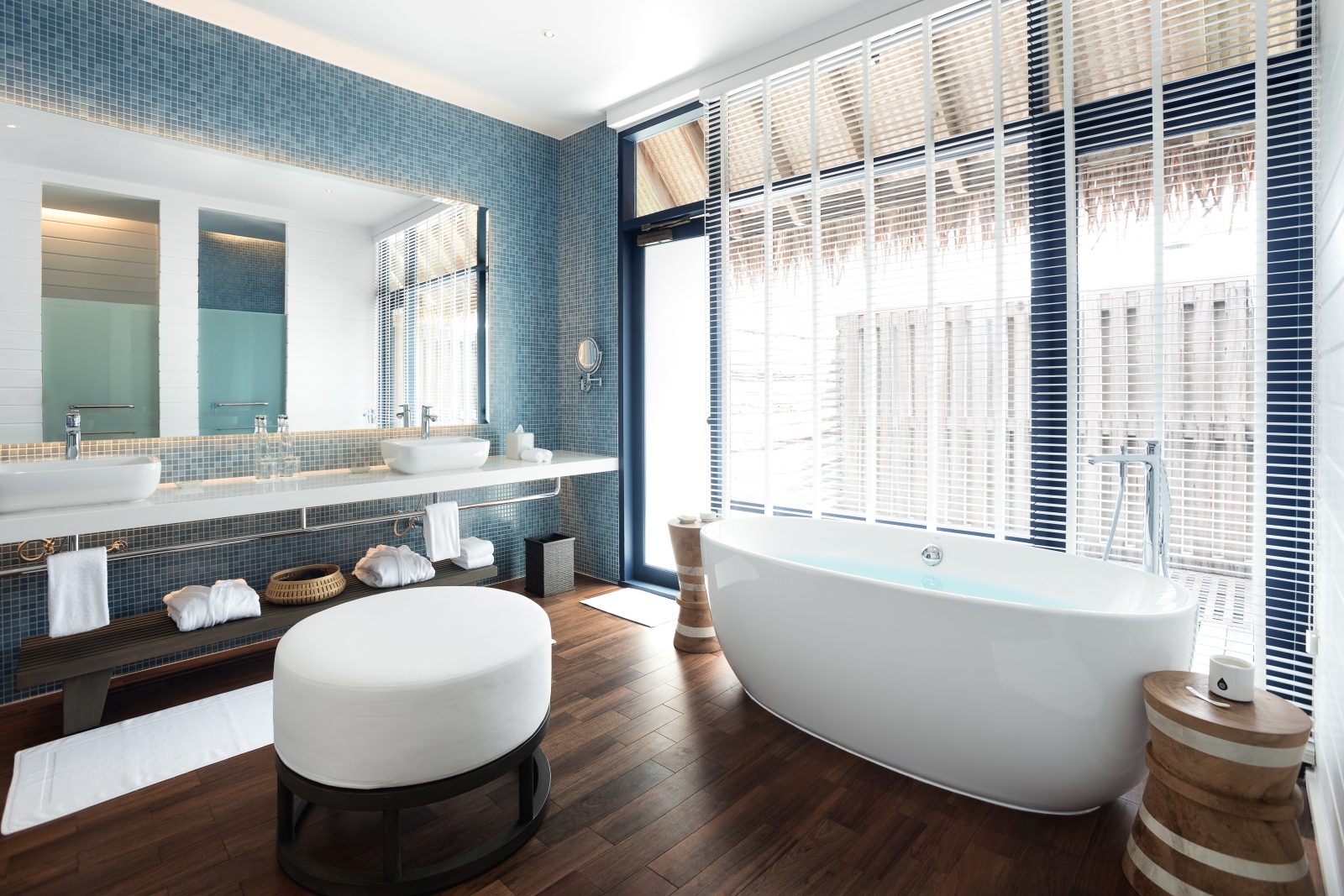 Bathroom with freestanding bathtub in a Water Villa at luxury resort Cocoa Island in the Maldives