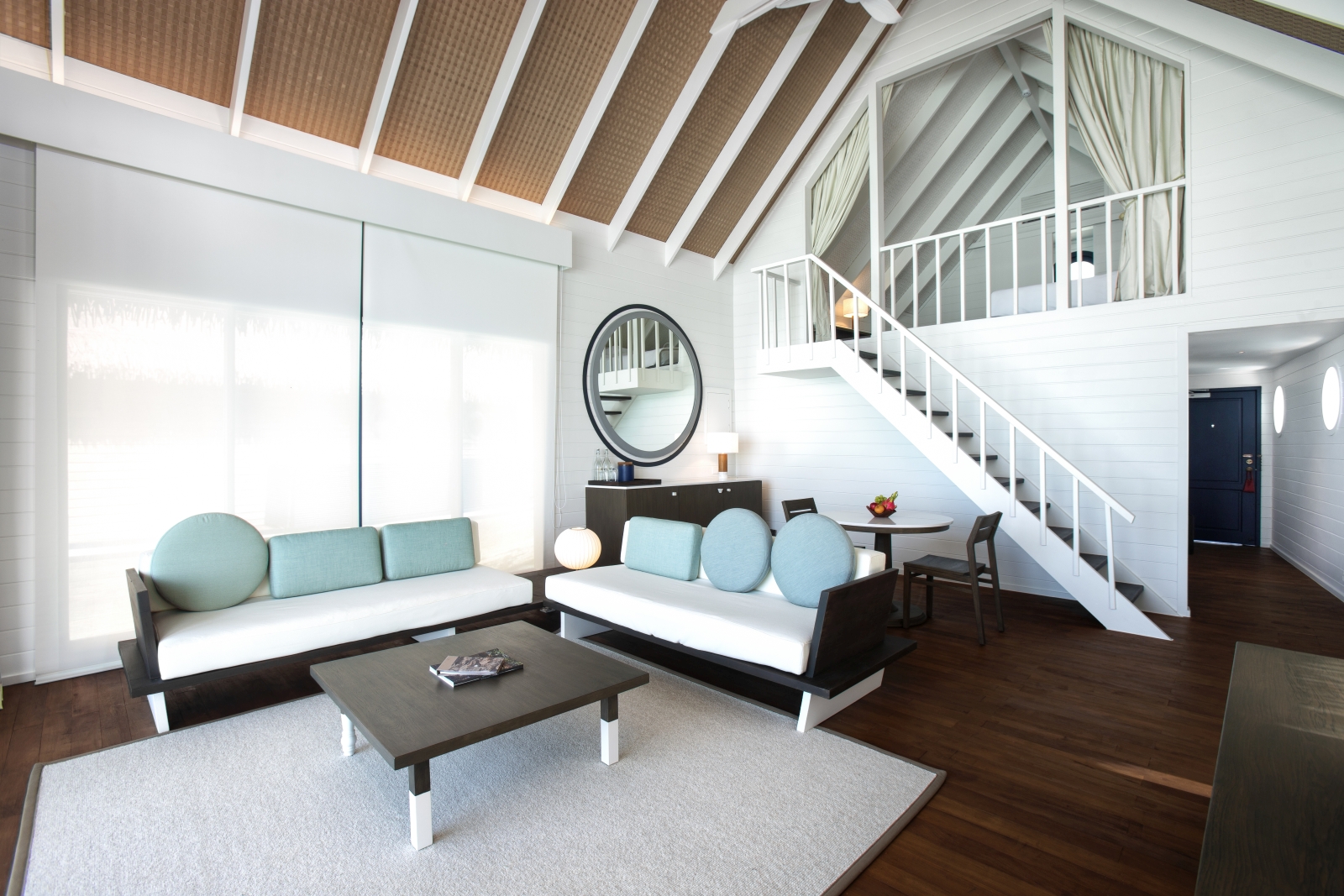 Living room of a Loft Water Villa at luxury resort Cocoa Island in the Maldives