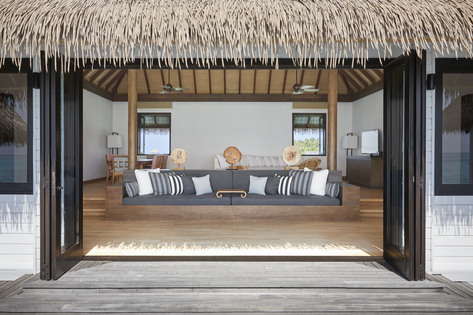 View into the lounge of a two-bedroom Water Villa at luxury resort COMO Maalifushi in the Maldives