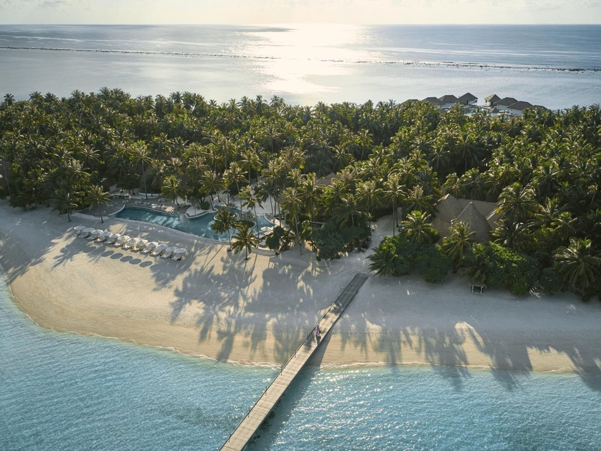Aerial view of the beach and main pool at luxury resort COMO Maalifushi in the Maldives