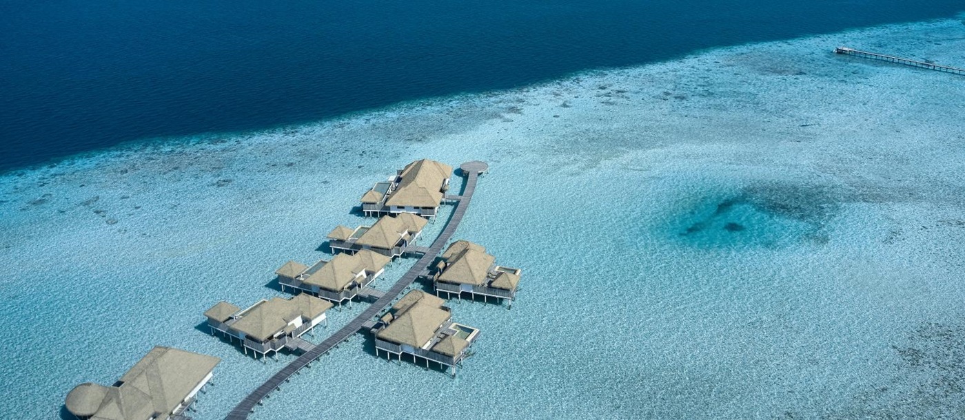 Aerial view over Water Villas at luxury resort COMO Maalifushi in the Maldives