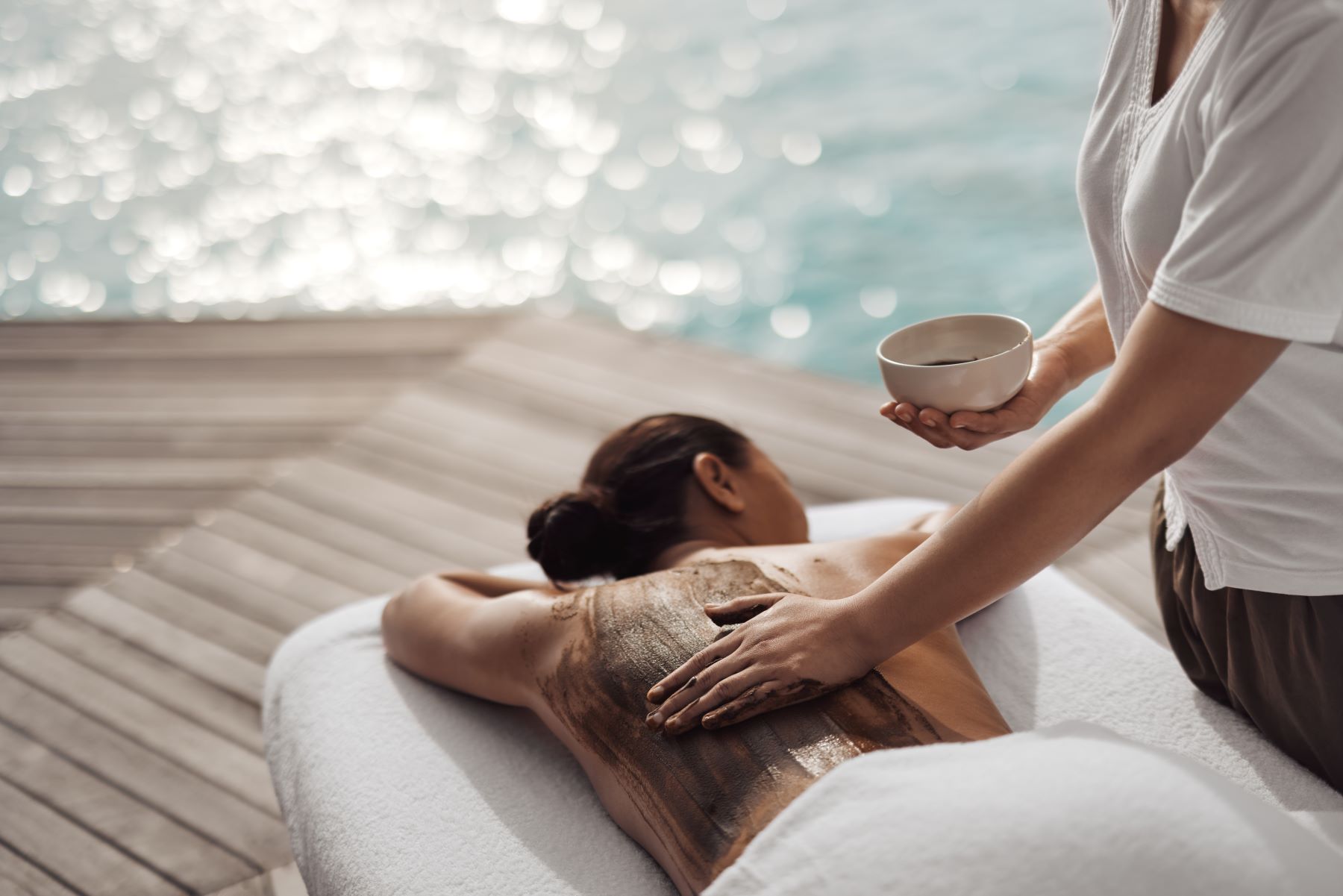 A guest receiving a body treatment at COMO Shambala wellness retreat at COMO Maalifushi in the Maldives