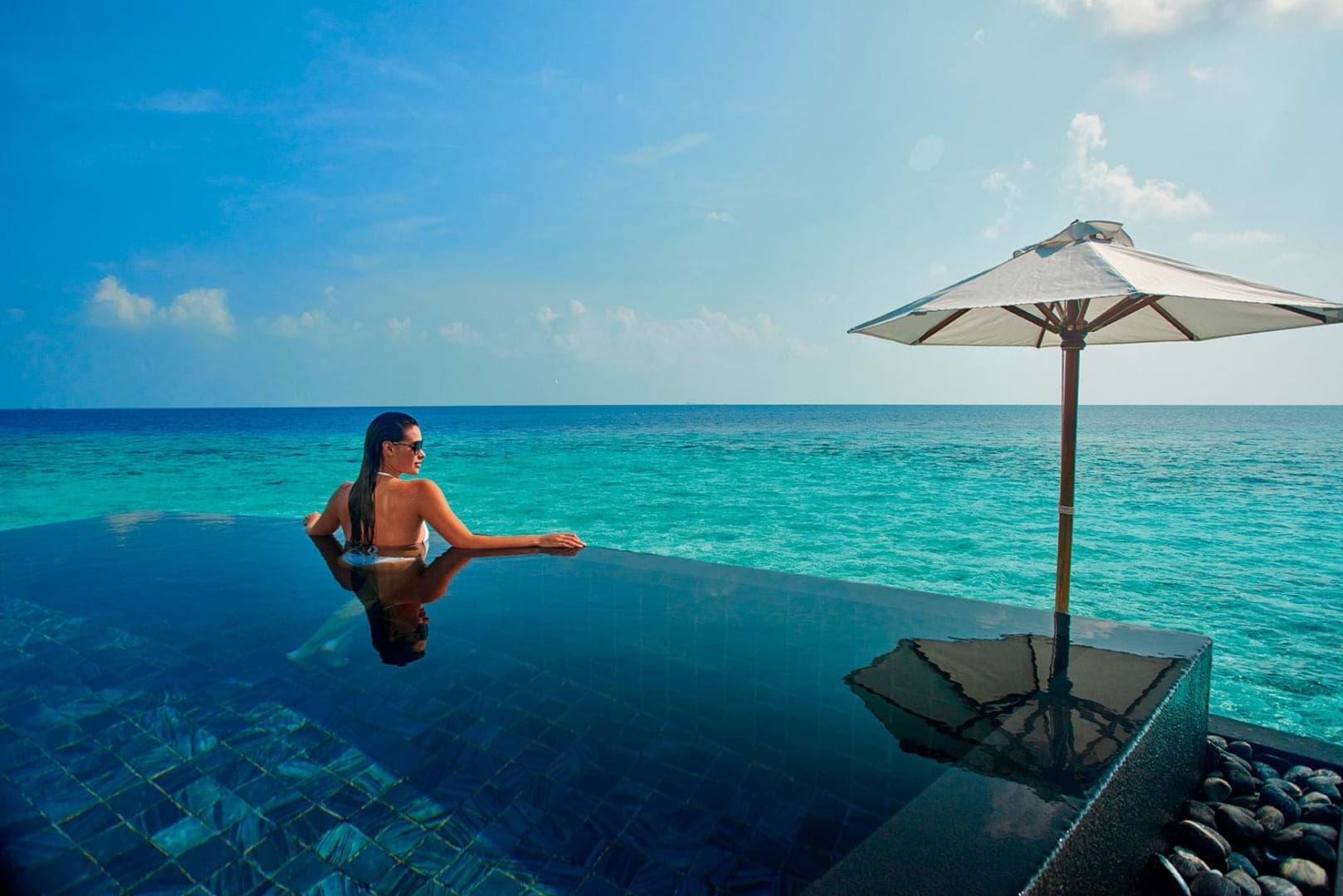 Guest enjoying private plunge pool at Constance Halaveli Maldives