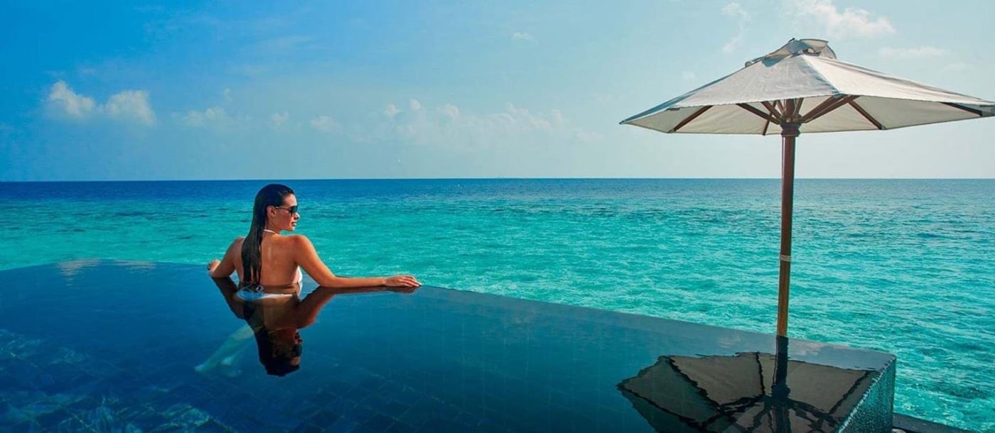Guest enjoying private plunge pool at Constance Halaveli Maldives