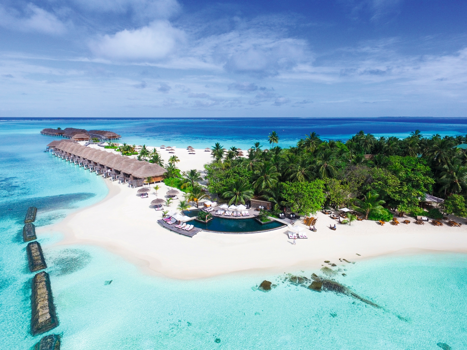 Aerial view of the pool at luxury resort Constance Moofushi in the Maldives