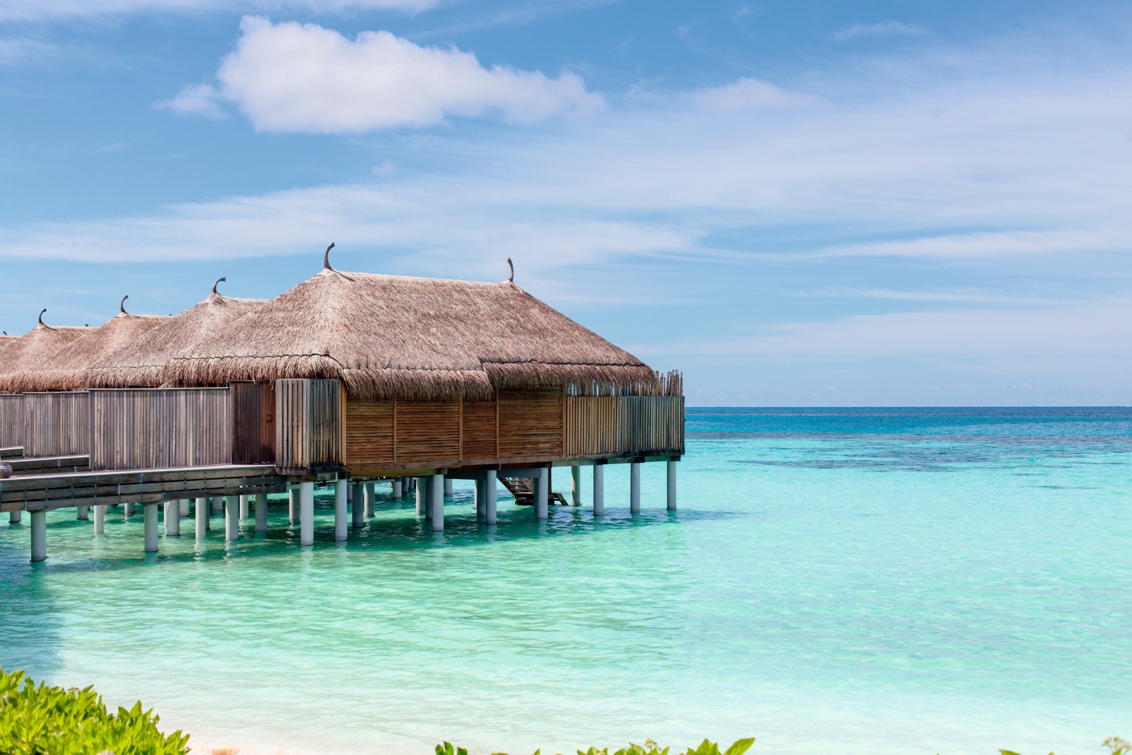 Overwater villas at luxury resort Constance Moofushi in the Maldives