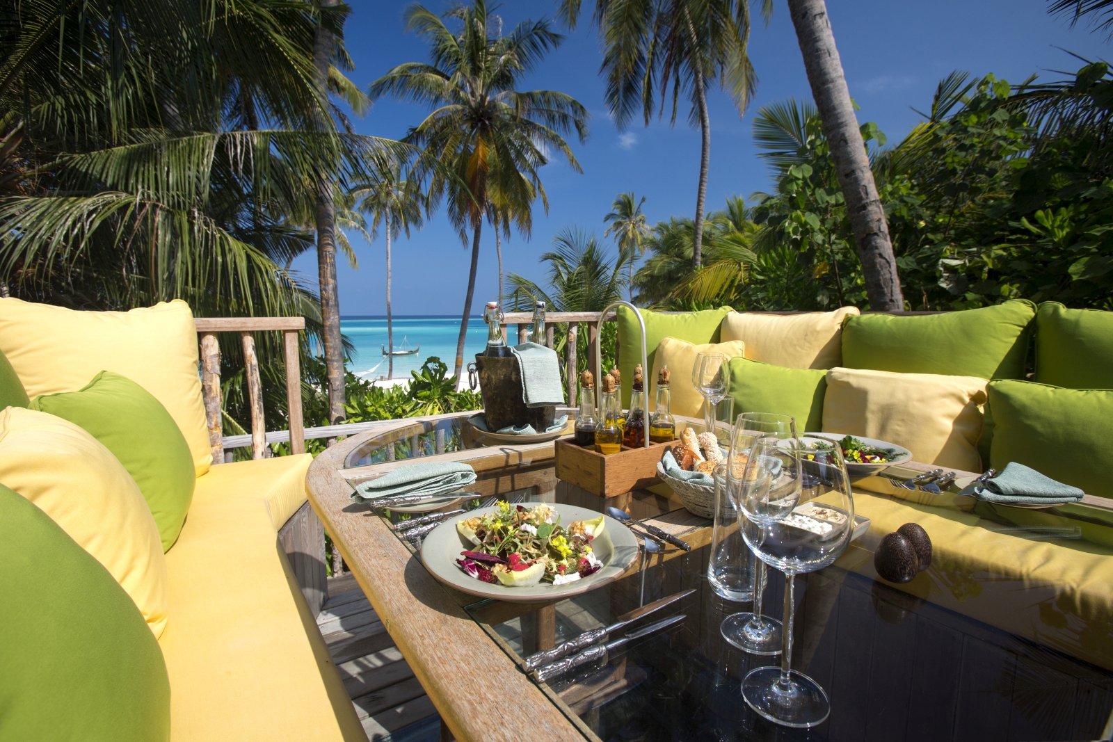 Destination dining on a terrace with views over the turquoise Indian Ocean at luxury resort Gili Lankanfushi in the Maldives