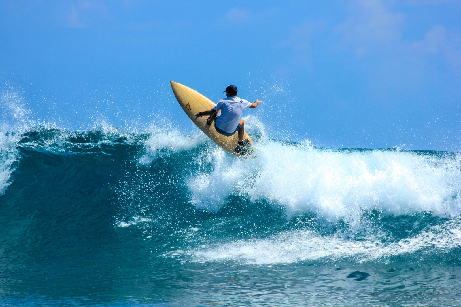 Guest surfing at luxury resort Gili Lankanfushi in the Maldives