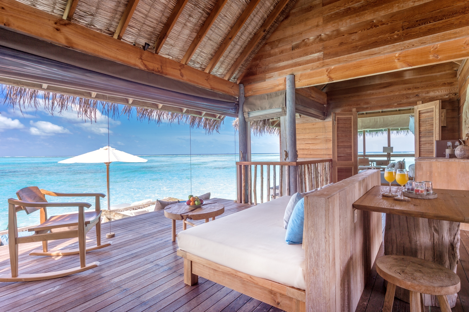 Living Room with seating and dining area and views over the Indian Ocean at luxury resort Gili Lankanfushi in the Maldives