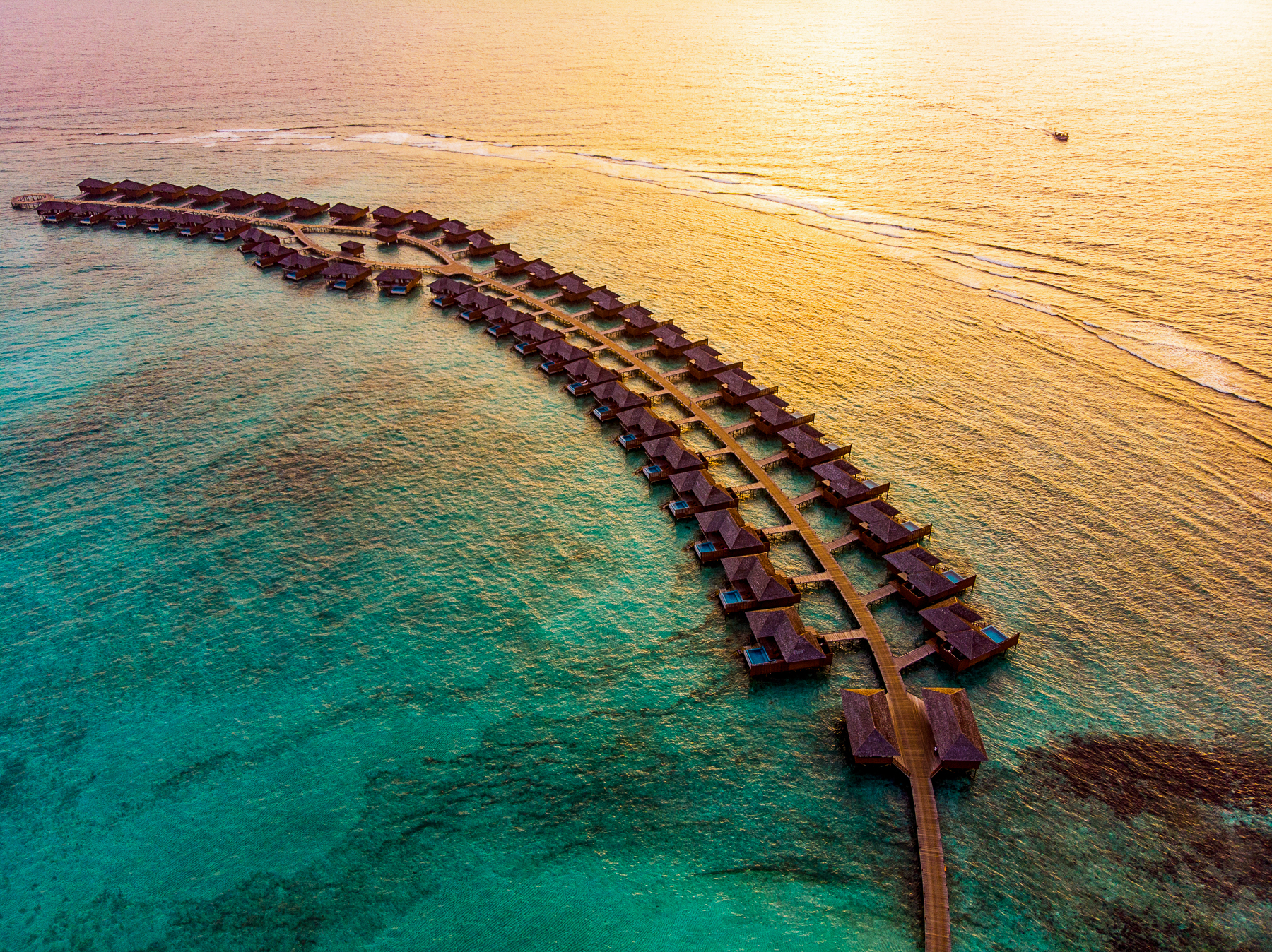 Aerial view of overwater villas at the Hideaway Beach Resort & Spa in the Maldives