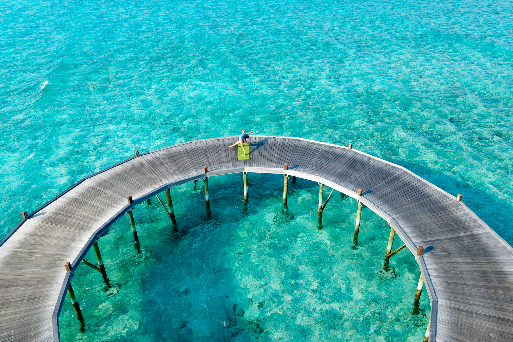 Yoga on the terrace walkway at the Hideaway Beach Resort & Spa in the Maldives