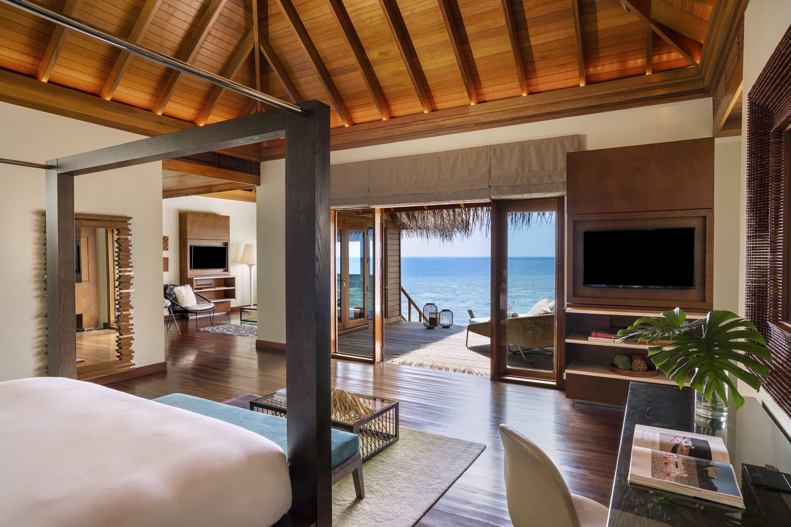 Bedroom with private terrace of an Ocean Pavilion at luxury resort Huvafen Fushi in the Maldives