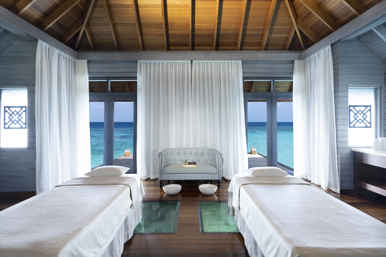 Overwater treatment room at the spa of luxury resort Huvafen Fushi in the Maldives