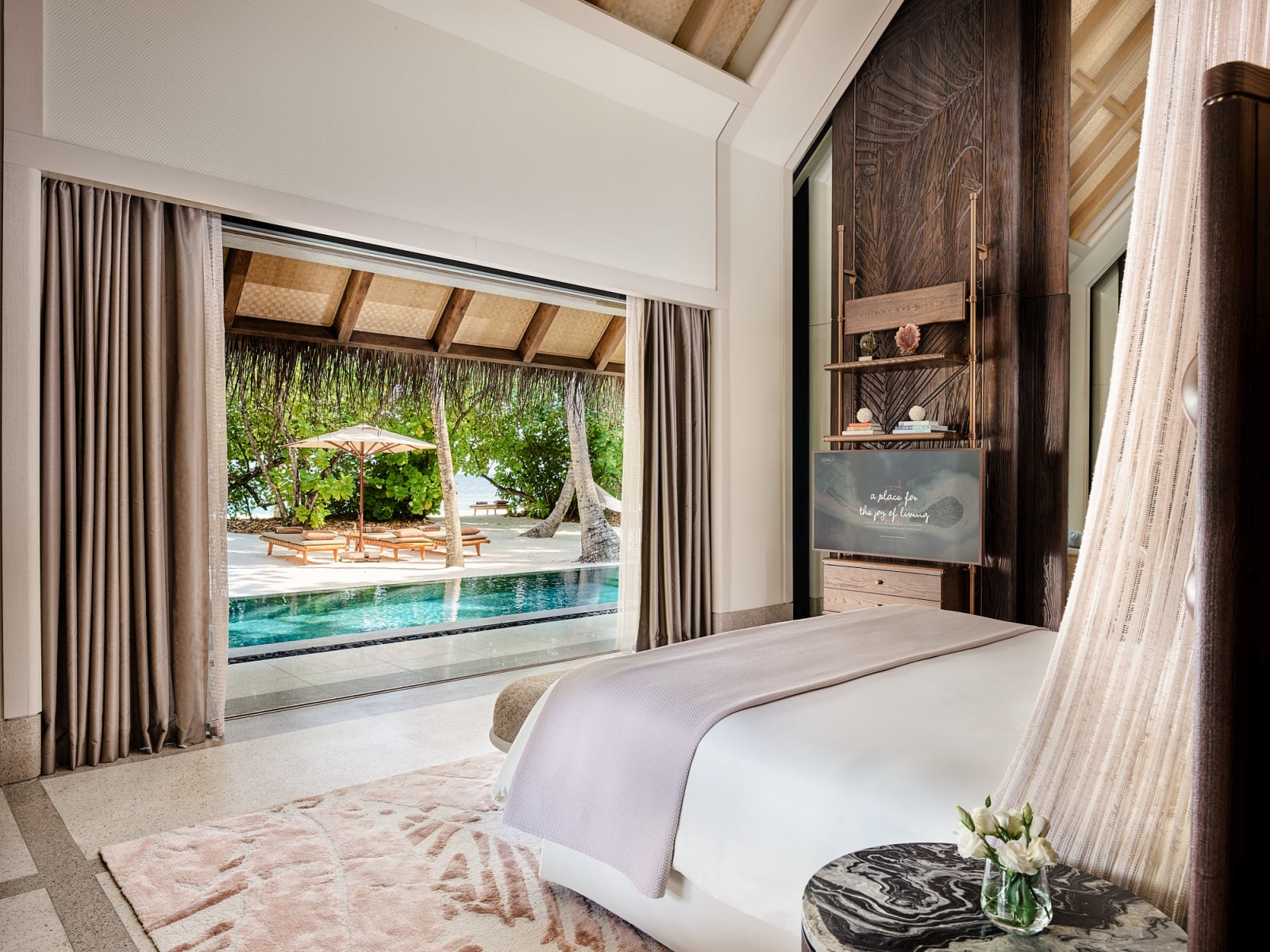 Bedroom overlooking the private pool at a Family Beach Villa at luxury resort Joali in the Maldives