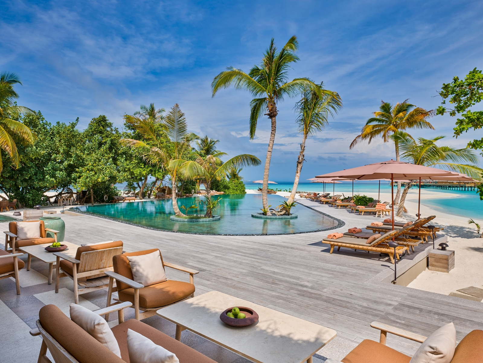 View over the palm-lined main pool at luxury resort Joali in the Maldives