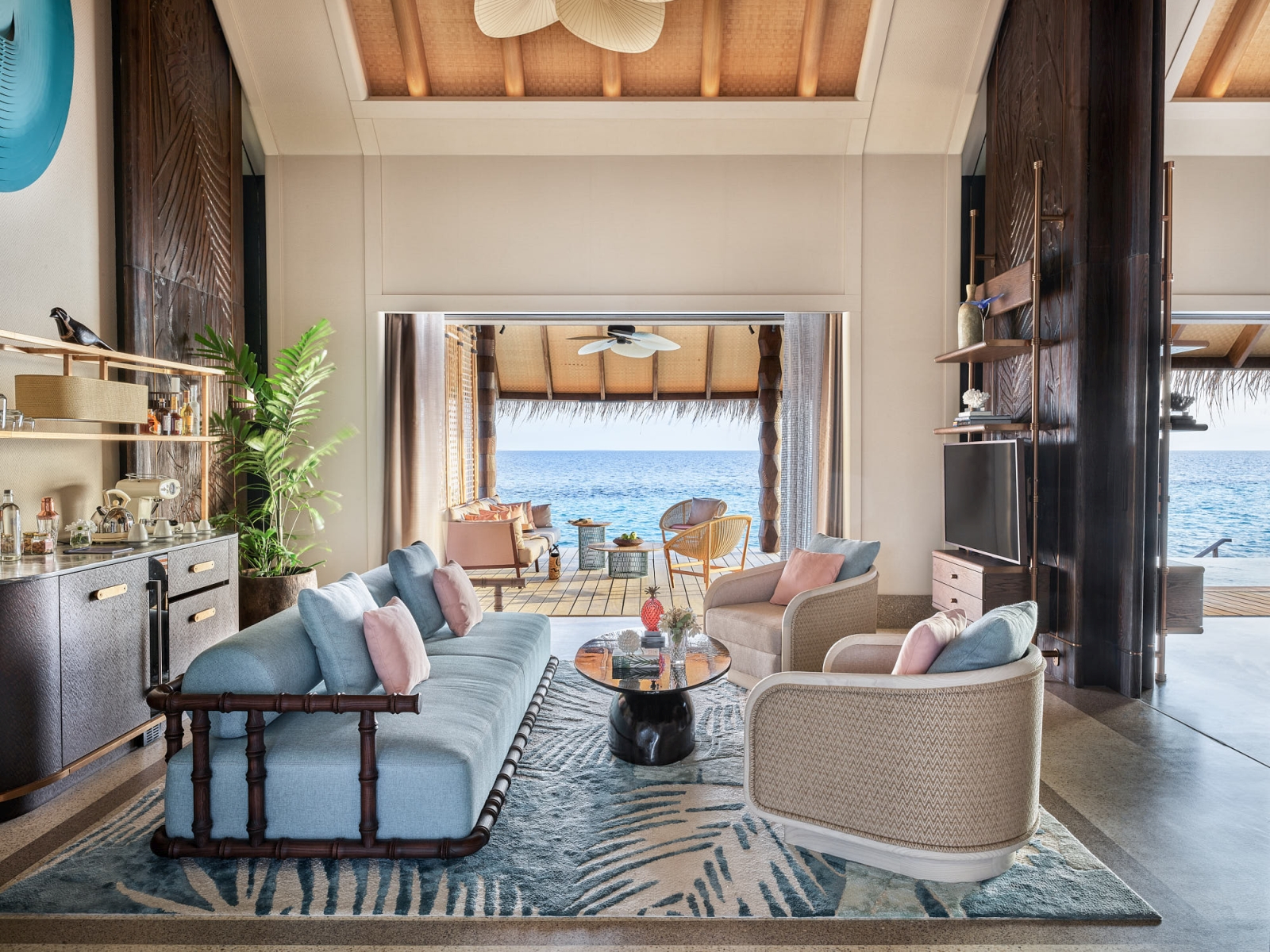Living Room of a Sunset Luxury Water Villa with pastel colours at luxury resort Joali in the Maldives