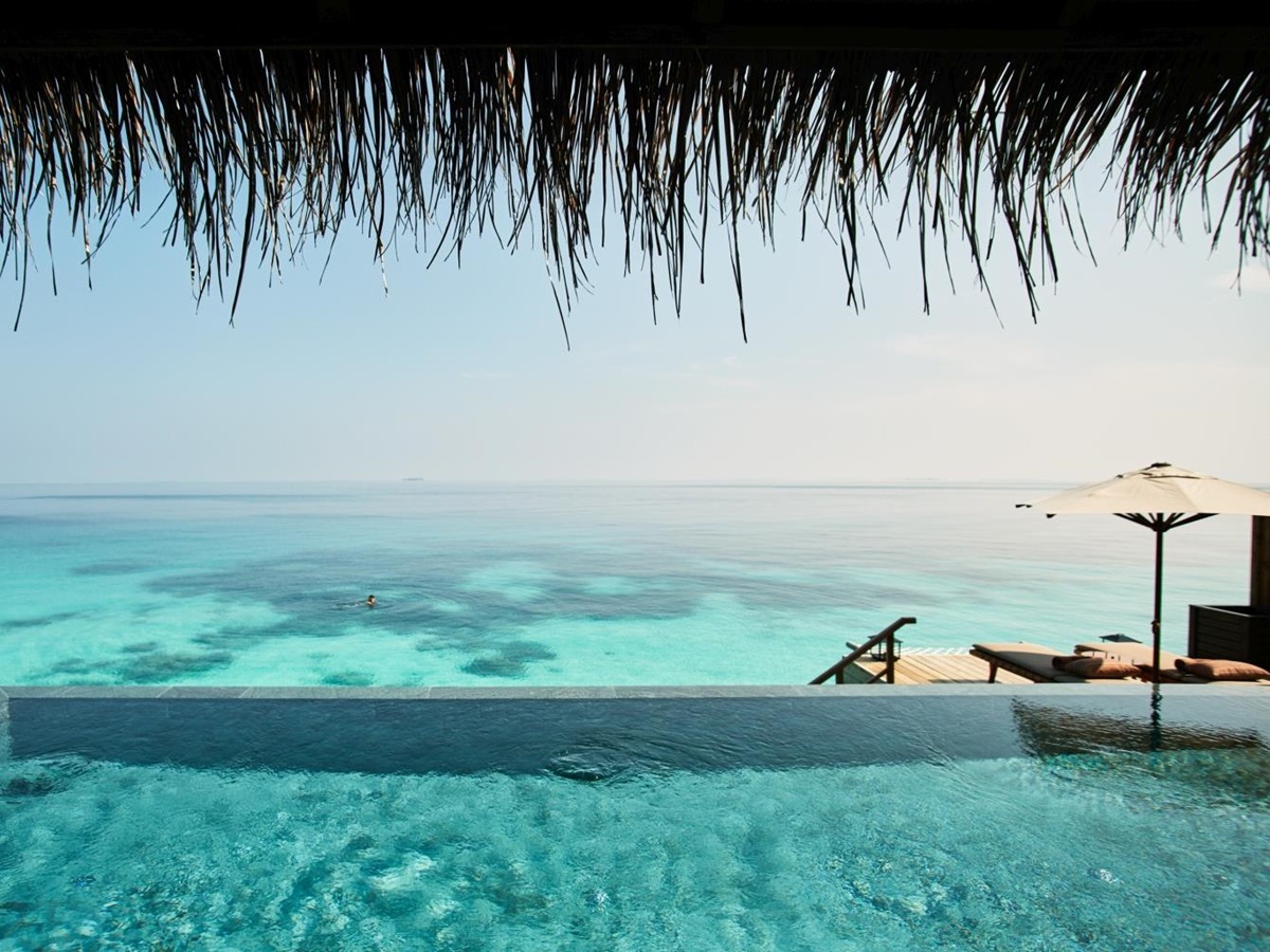 A view out to the Indian Ocean from a Water Villa including a view of the pool
