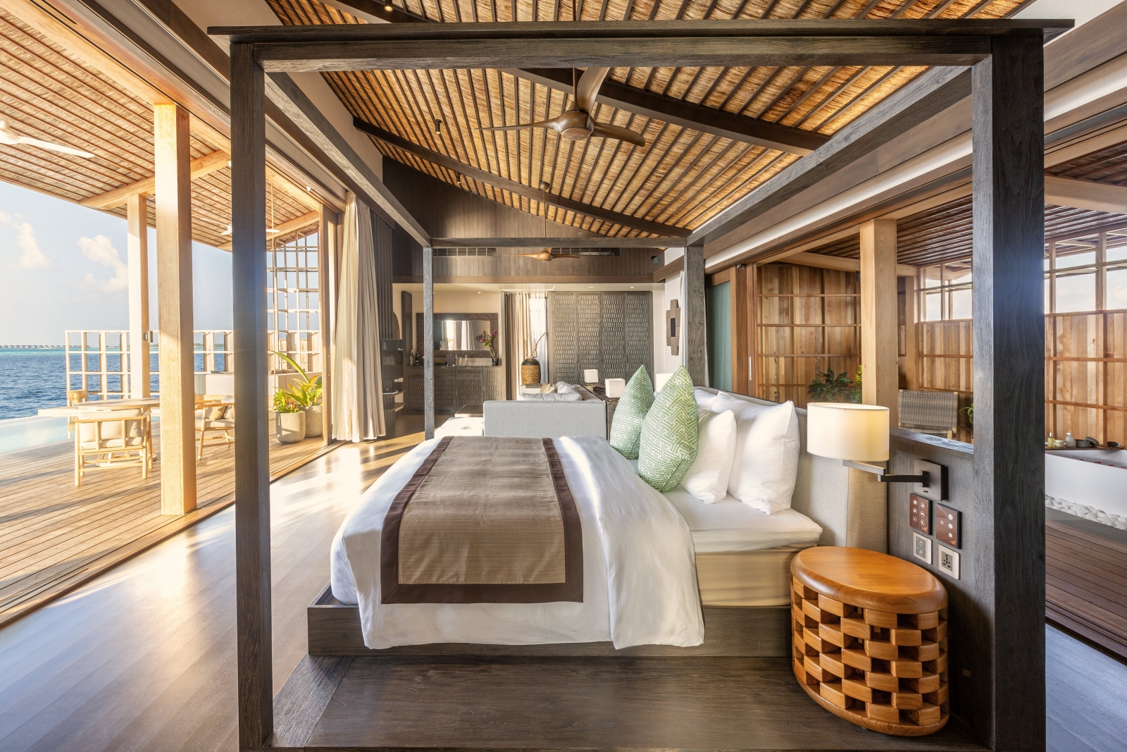 Interior of a residence at luxury resort Kudadoo Private Island in the Maldives with four poster bed and views over the Indian Ocean