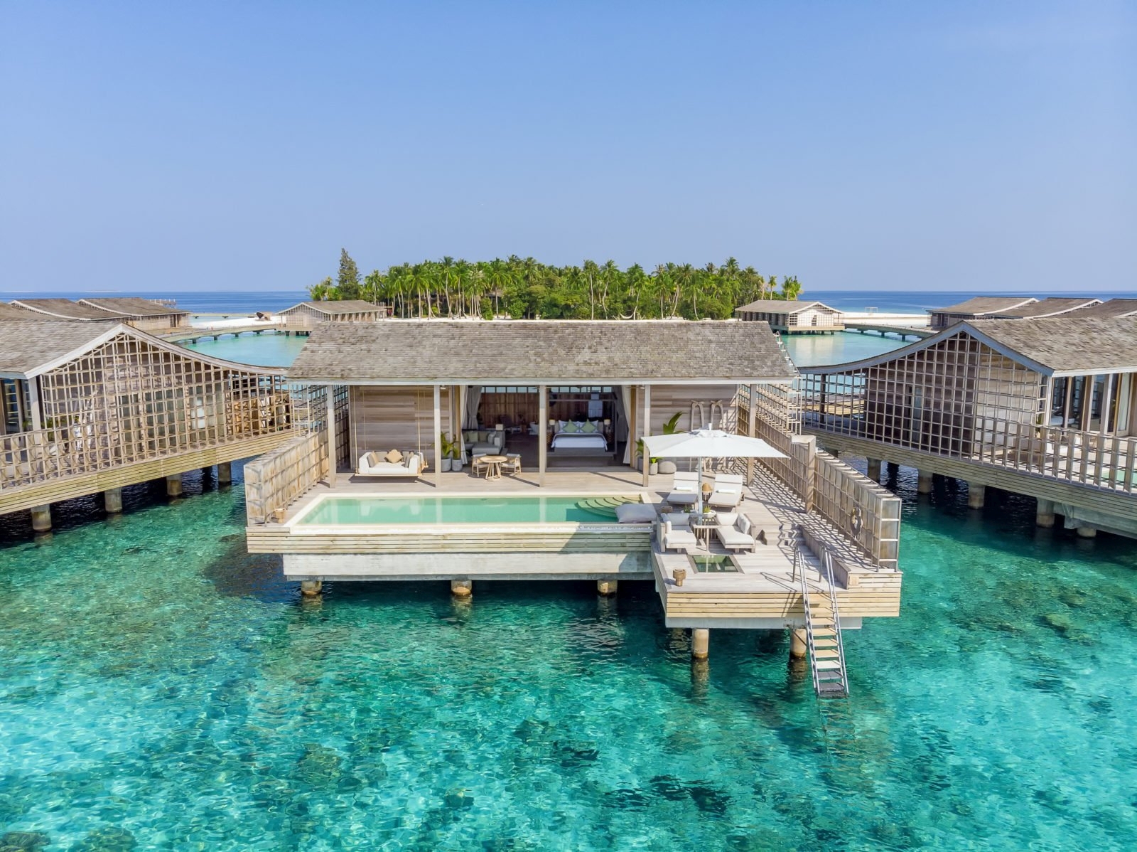 Exterior ov an overwater residence with private deck and pool at luxury resort Kudadoo Private Island in the Maldives