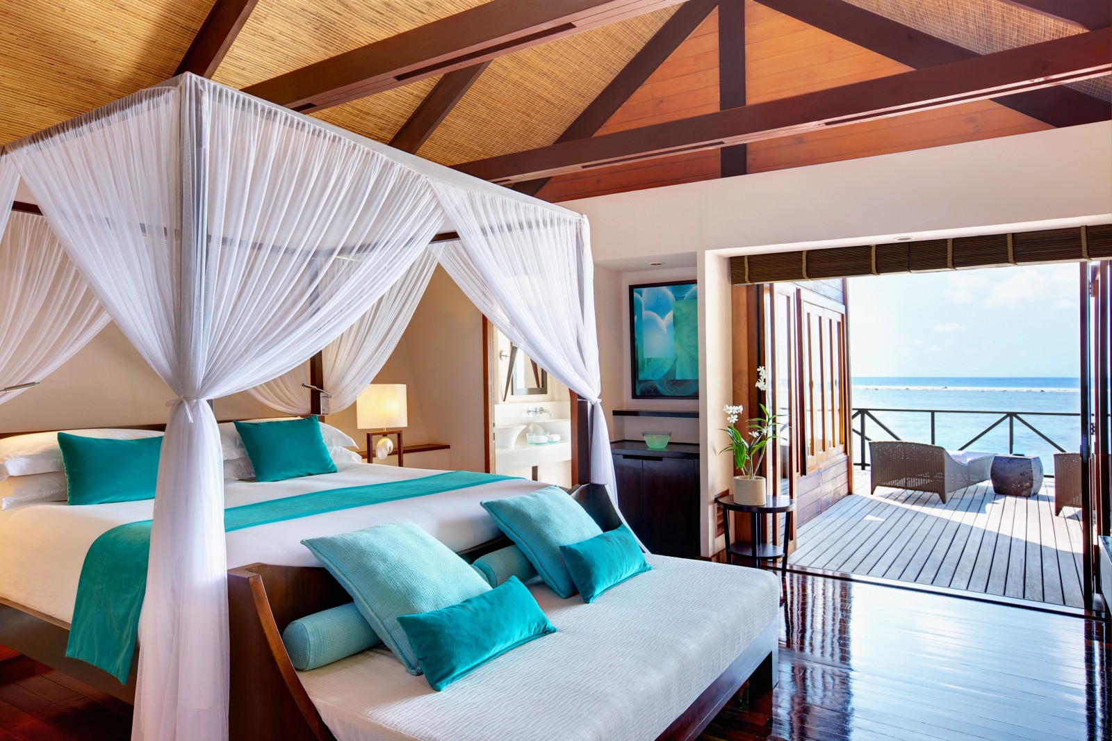 Double bedroom of a Water Villa at LUX Maldives