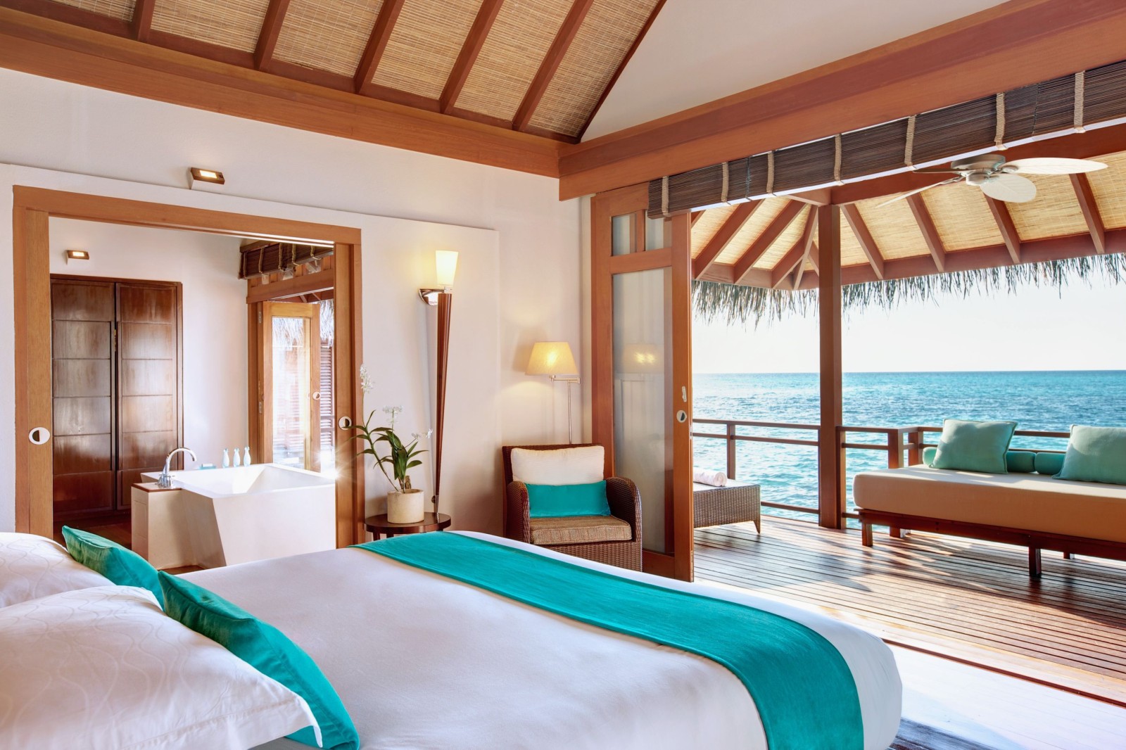 Double bedroom of a prestige water villa at LUX Maldives