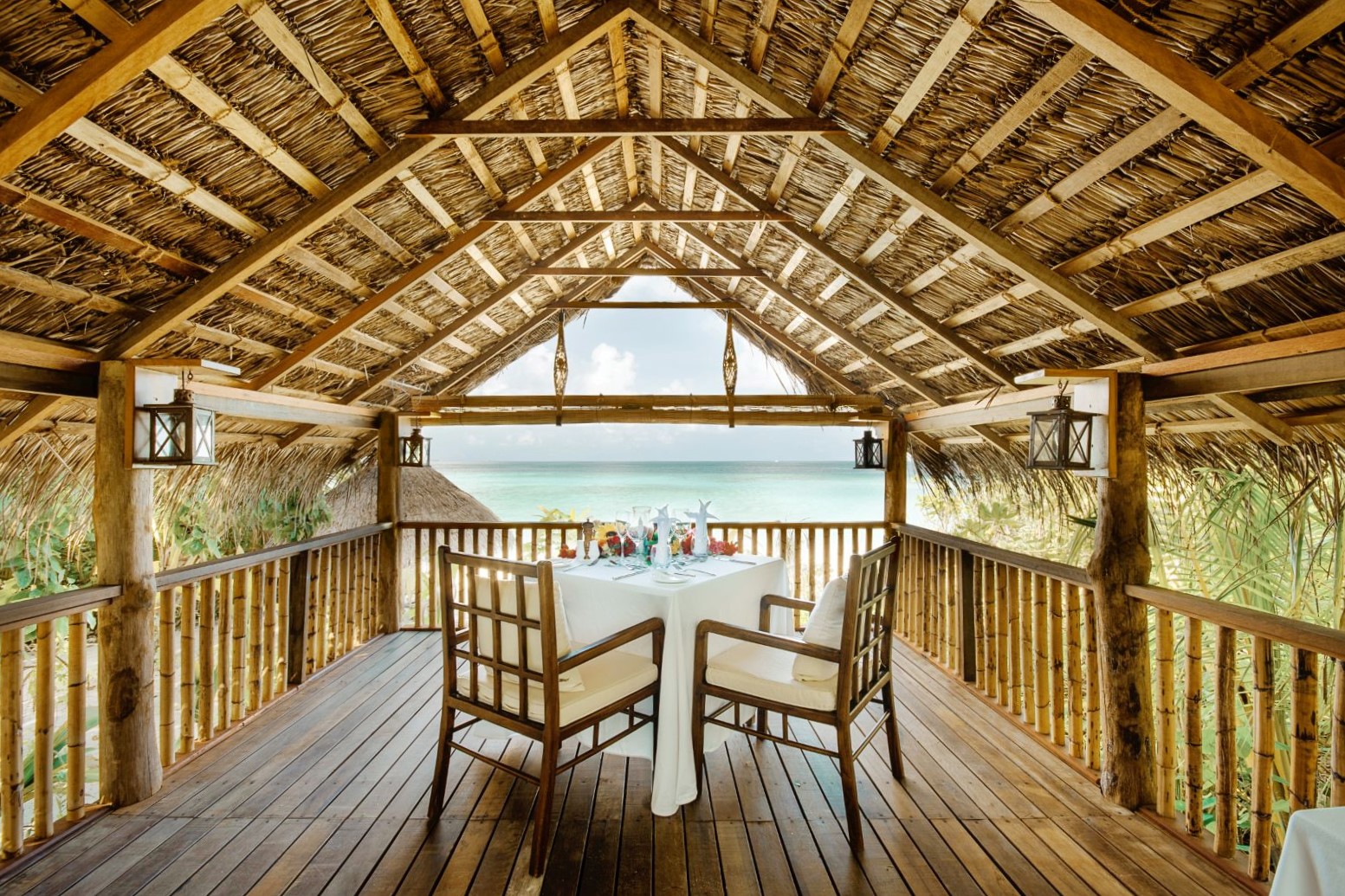 Breakfast table overlooking the beach at Mukunudu Island resort in the Maldives