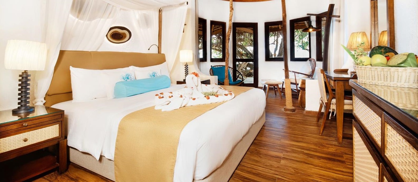 Double guest suite bedroom at Mukunudu Island resort in the Maldives
