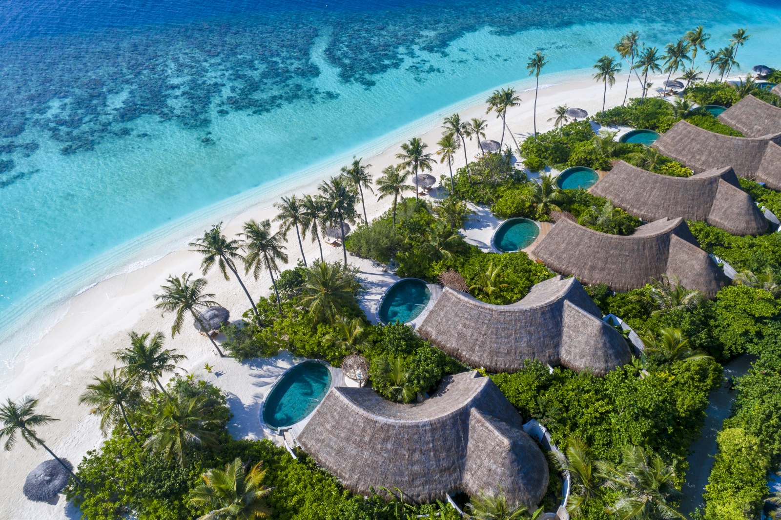 Aerial view over the Beach Pool Villas at luxury resort Milaidhoo in the Maldives