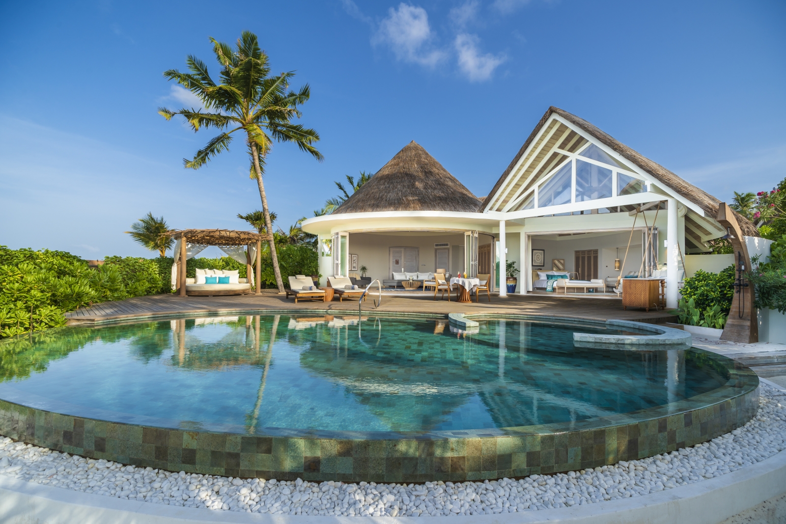 Exterior view of a Beach REsidence with private pool, pool cabana, loungers, open bedroom and living area at luxury resort Milaidhoo in the Maldives