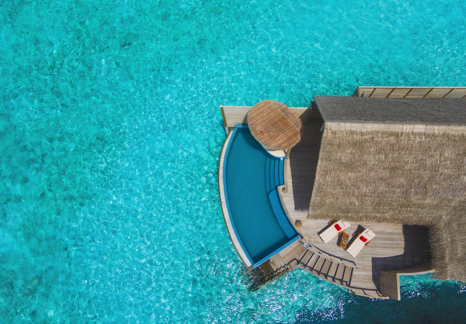 Aerial view of a water pool villa luxury resort Milaidhoo in the Maldives