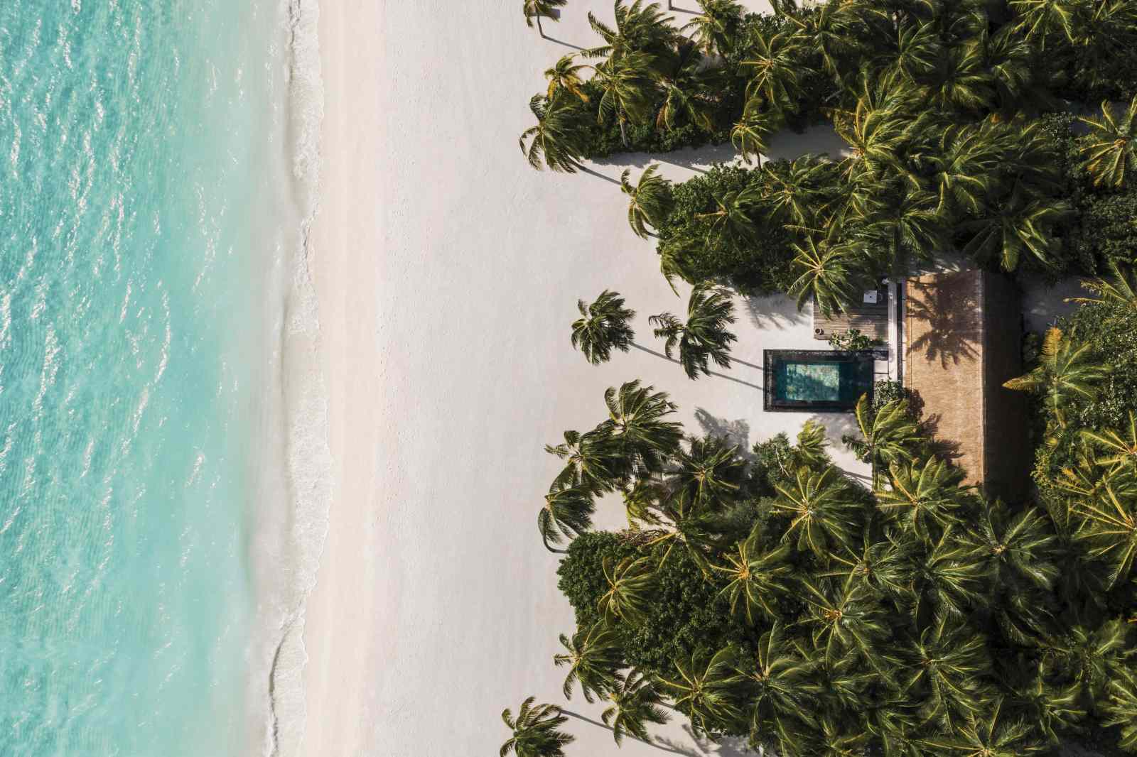 Aerial view of a villa and the beach at OneAndOnly Reethi Rah Maldives
