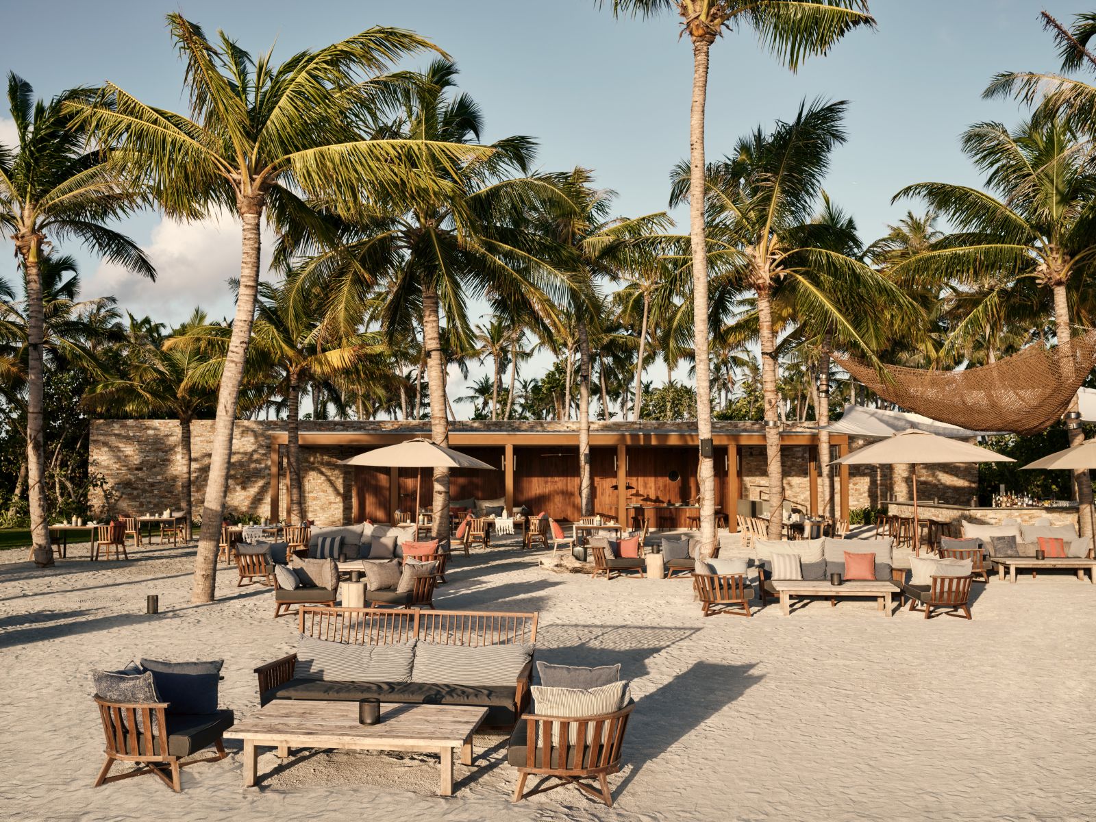 Exterior view of and beach seating at Helios at luxury resort Patina in the Maldives