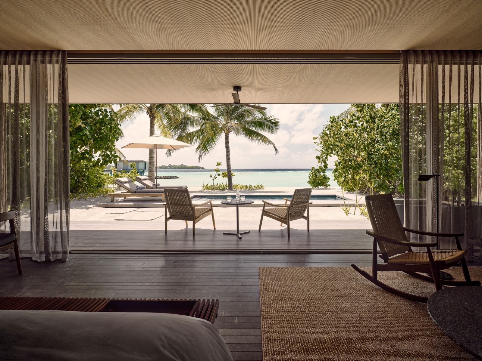 View over the private deck and pool as well as the beach in a Sunset Beach Villa at luxury resort Patina in the Maldives