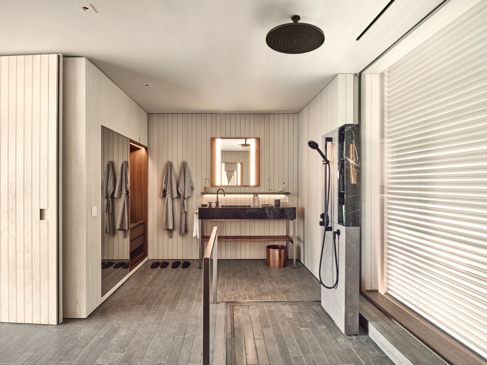 Bathroom of a water villa with open rain shower at luxury resort Patina in the Maldives