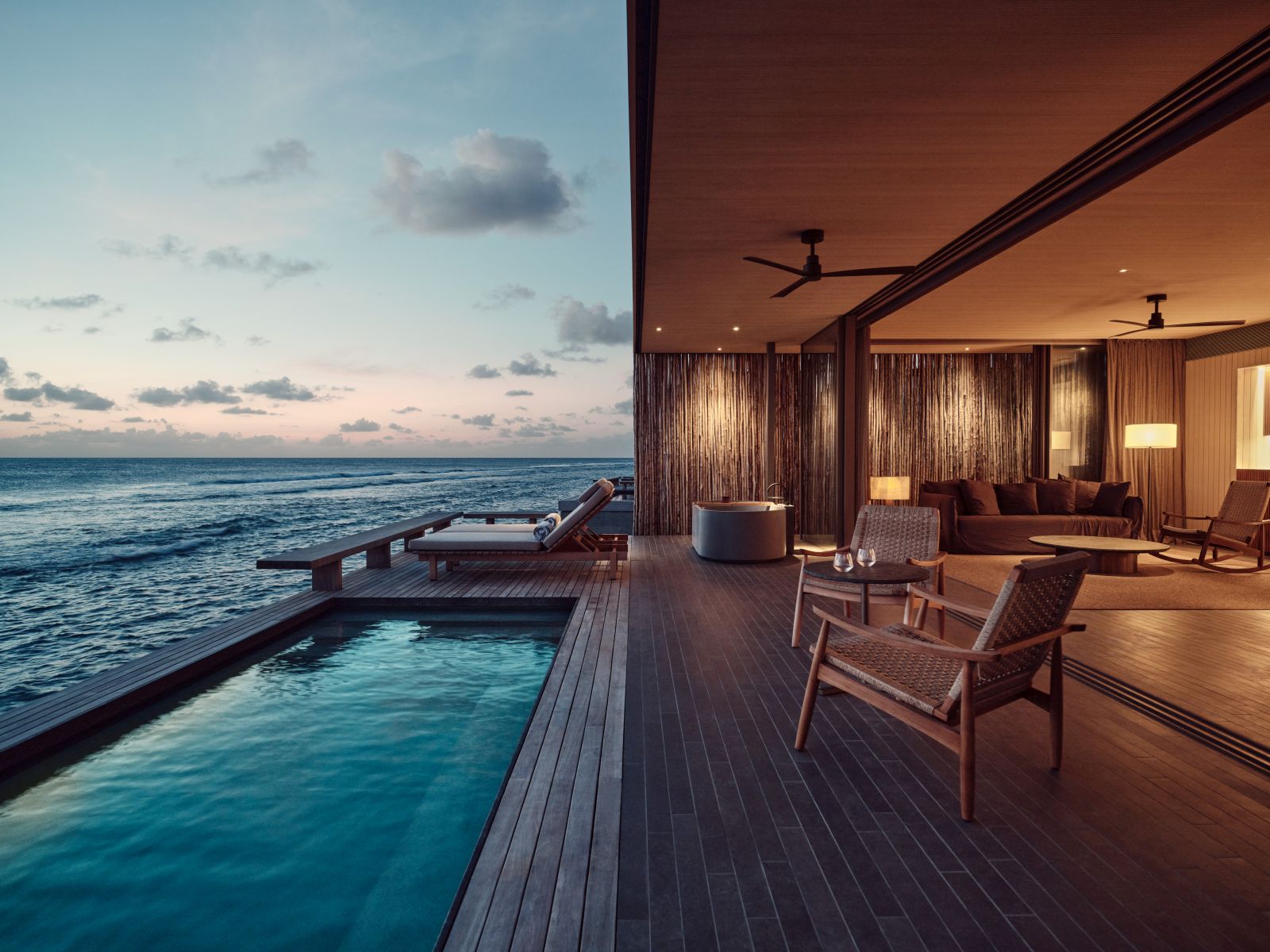 Private deck and pool of a water villa at luxury resort Patina in the Maldives