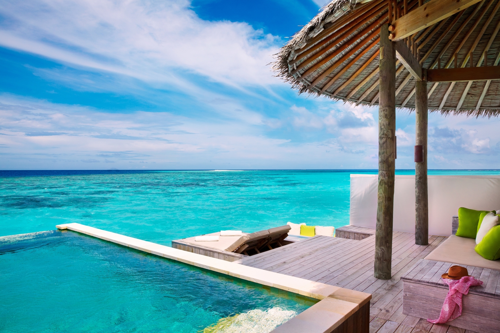 Terrace of a Water Villa with Pool, overlooking the Turquoise Indian Ocean at luxury resort Six Senses Laamu in the Maldives