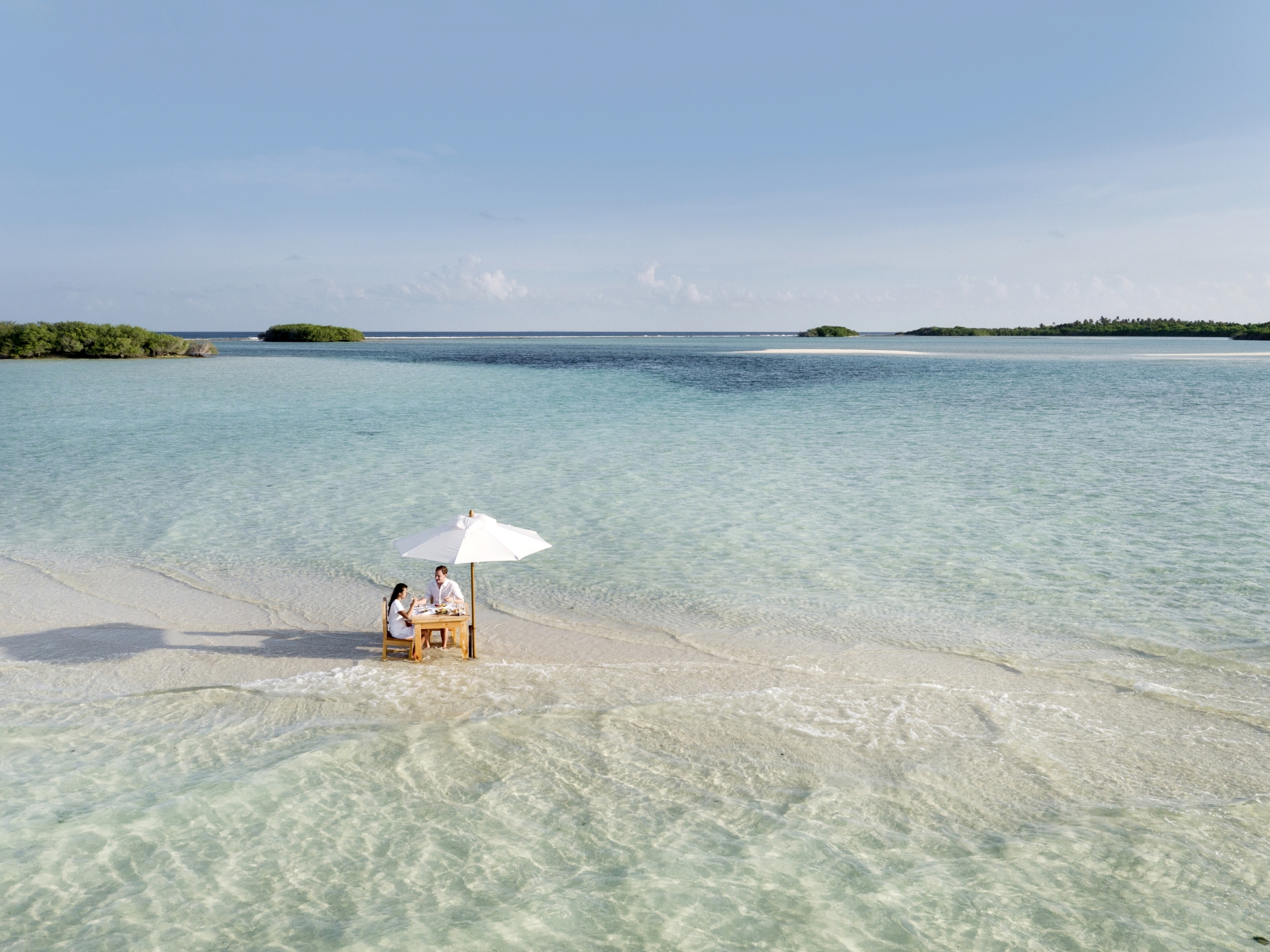Couple eating on a sandbank