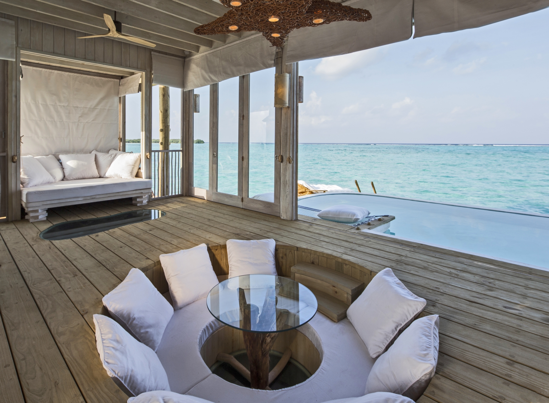 Overwater villa bedroom at Soneva Jani by Richard Waite