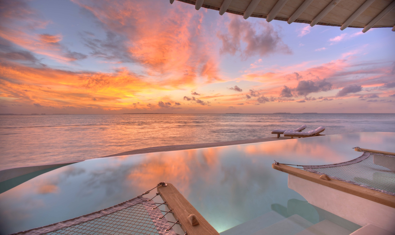 Sunset with over water villa by Steve Mann