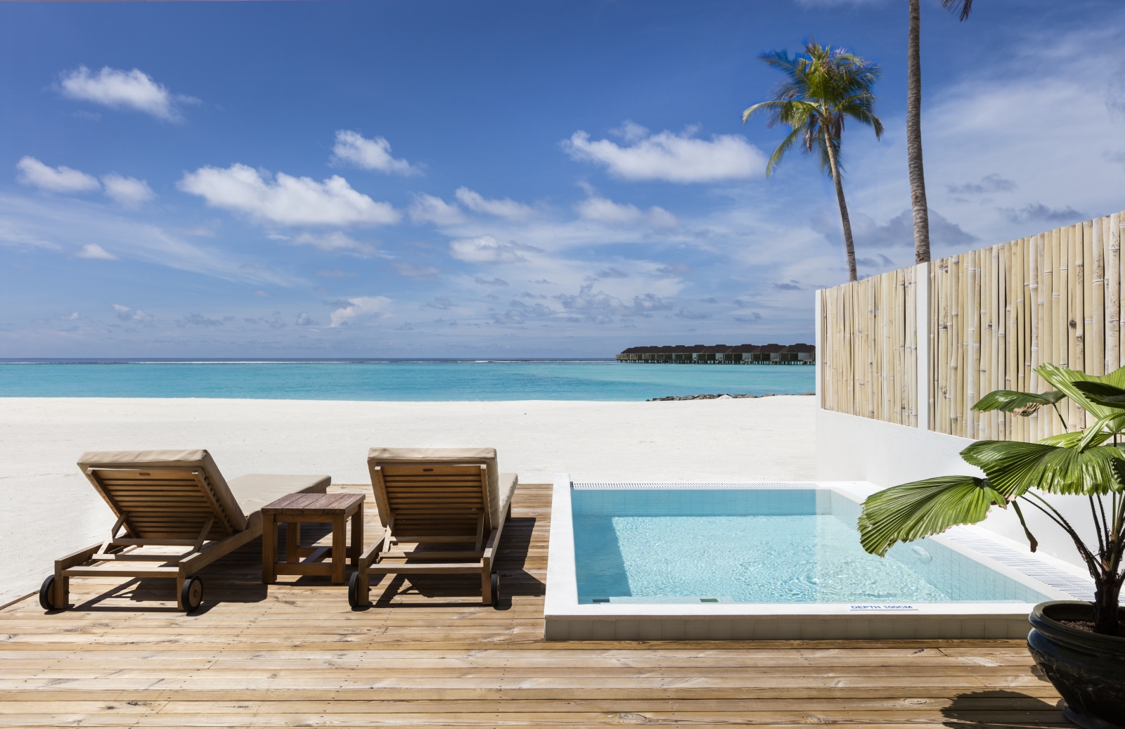 Two loungers by the private pool of a Beach Villa at luxury resort Sun Siyam Olhuveli in the Maldives