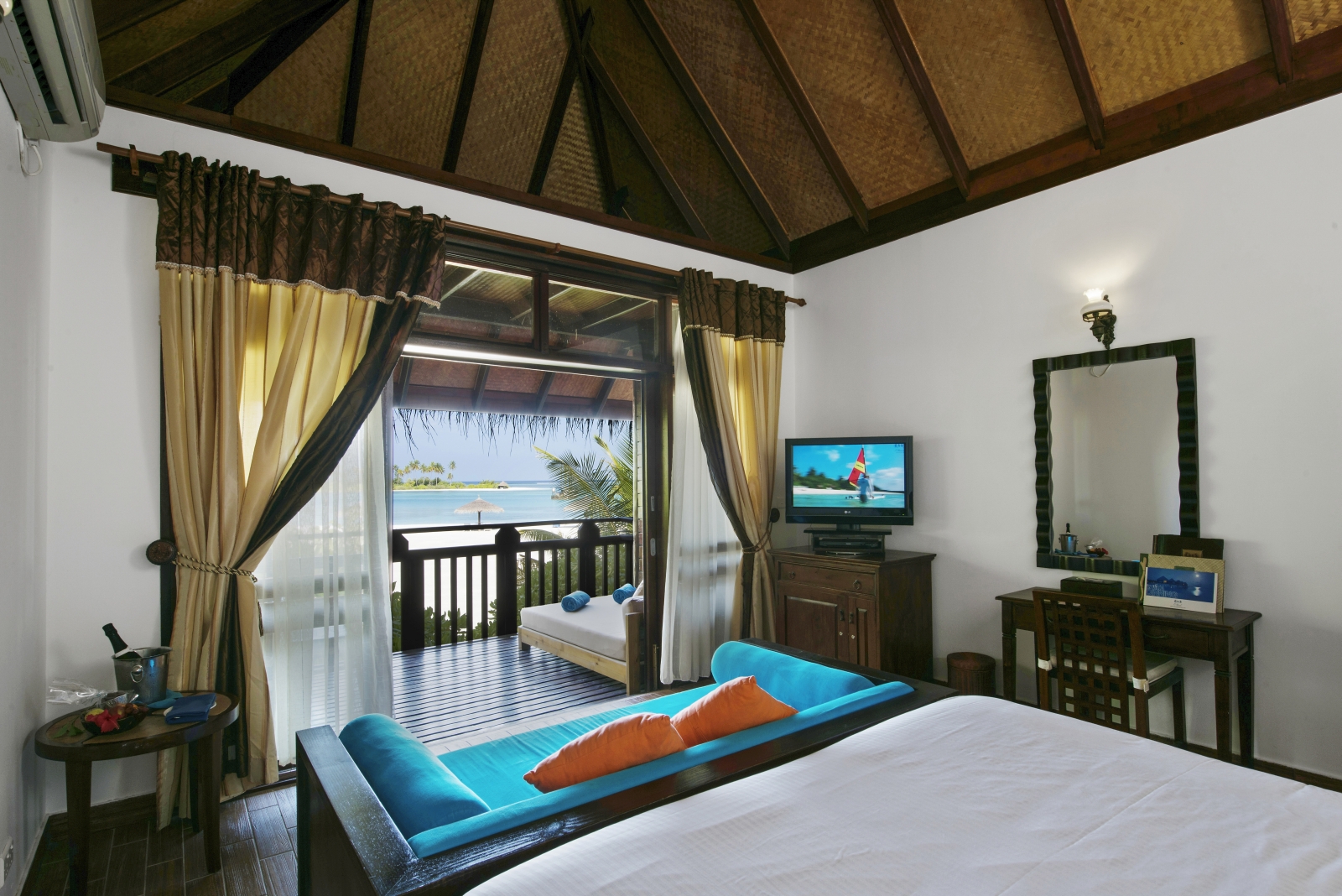 Bedroom of a Beach Villa with views over the beach and private terrace at luxury resort Sun Siyam Olhuveli in the Maldives