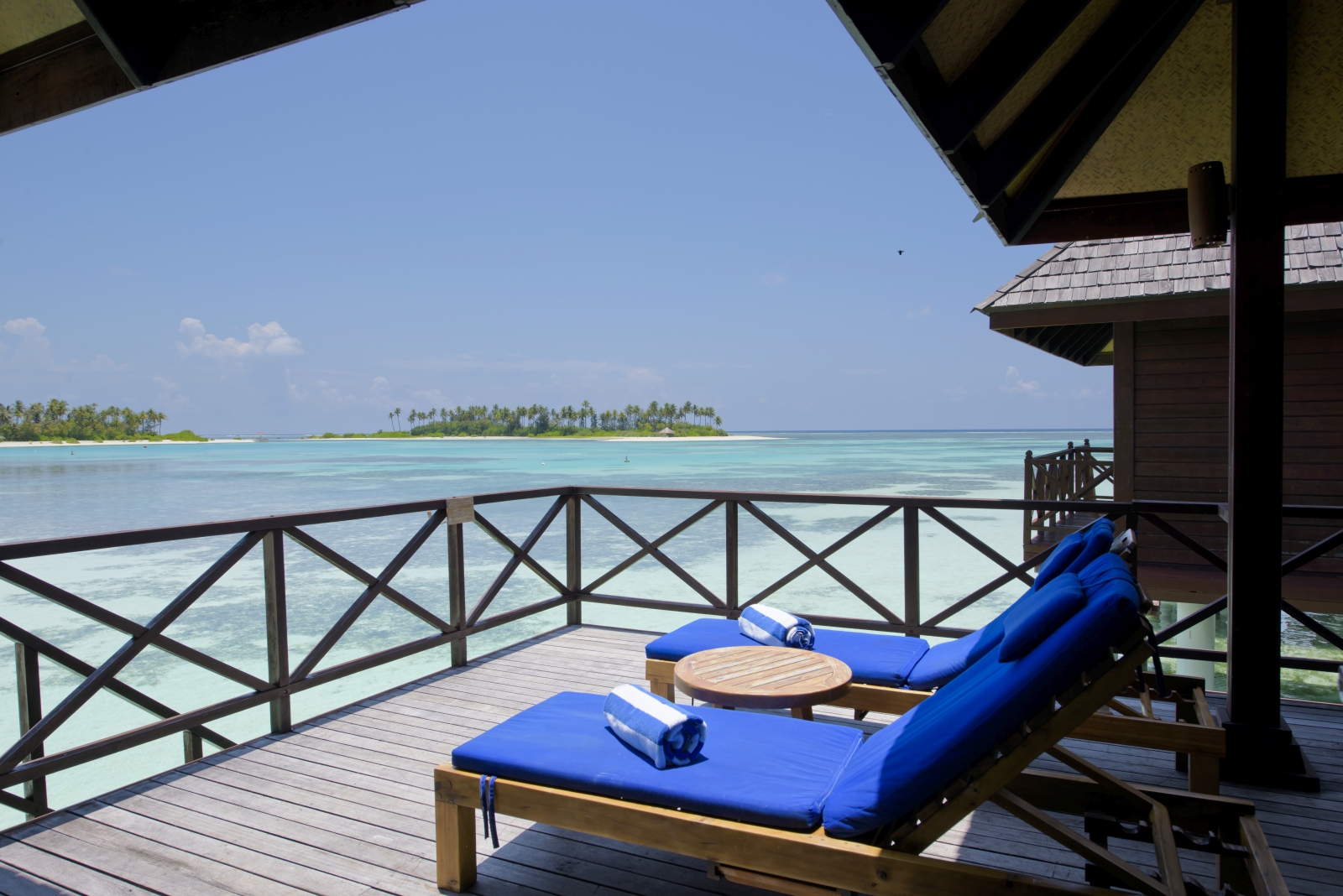Two sunloungers on a private terrace at luxury resort Sun Siyam Olhuveli in the Maldives