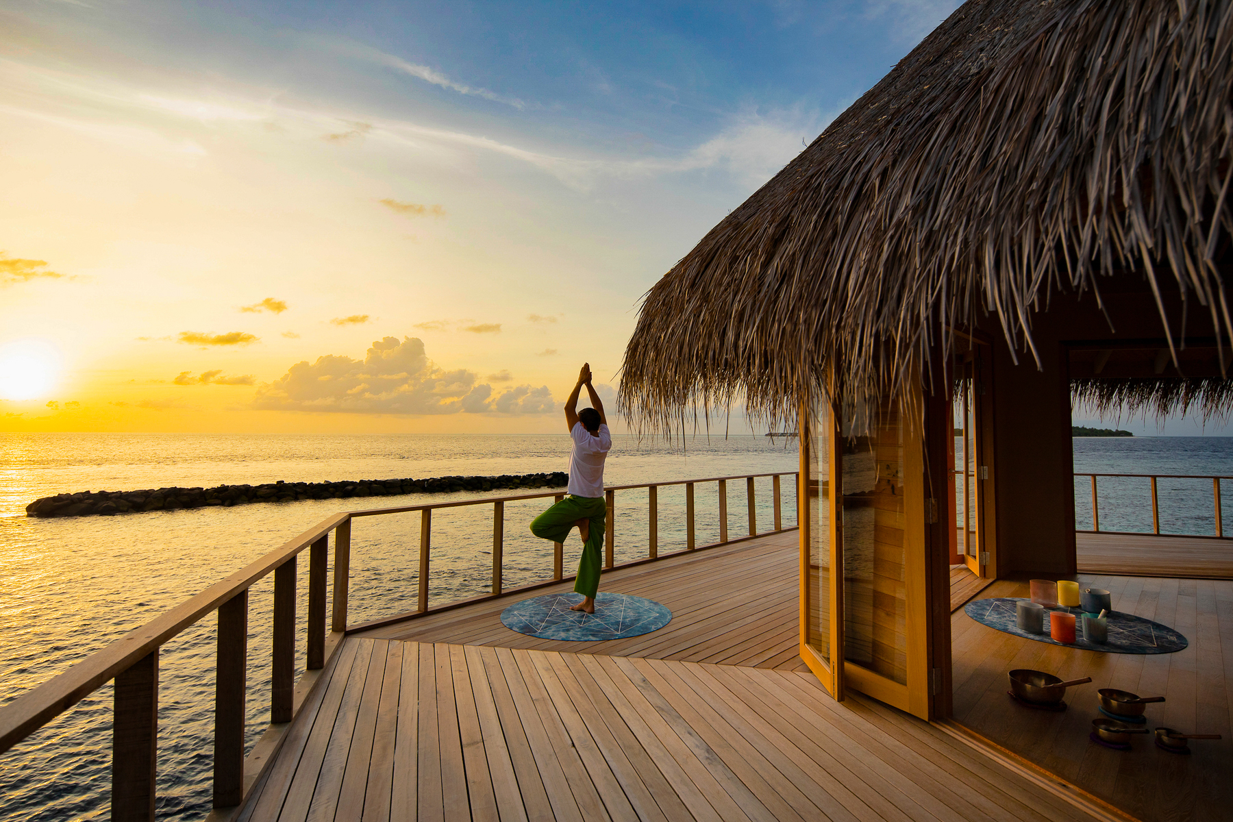 A man doing yoga at The Nautilus in the Maldives